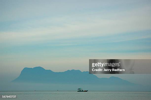 Fishing boat passes between Gunung Santubong and Bako National Park. The area is a fertile fishing ground..