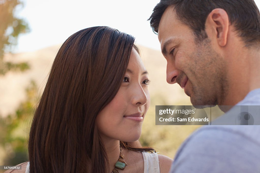 Smiling couple hugging outdoors