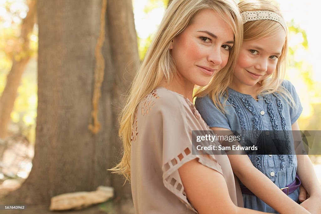 Mother holding daughter outdoors