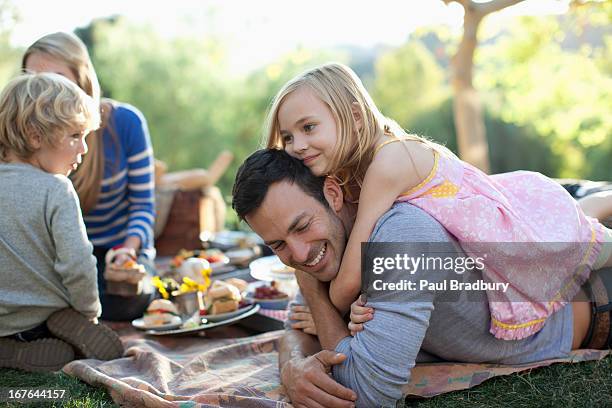 family picnicking together outdoors - picnic stock pictures, royalty-free photos & images