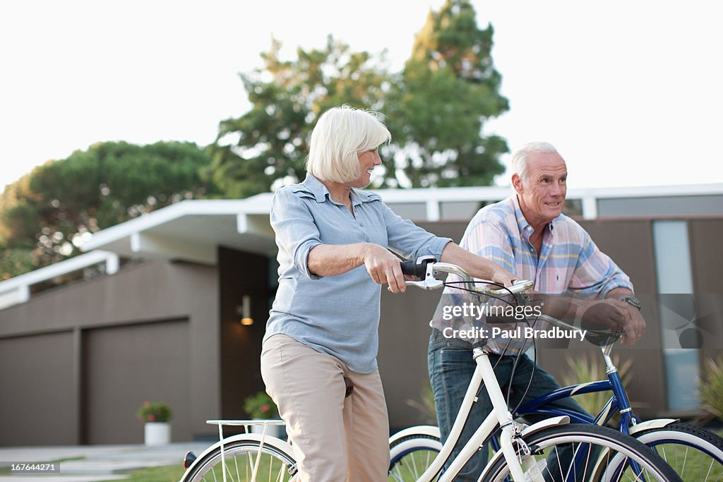 Older couple riding bicycles together