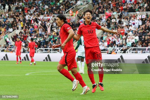 Cho Gue-Sung of Republic of Korea celebrates with teammate Lee Jae-Sung of Republic of Korea after scoring the team's first goal during the...