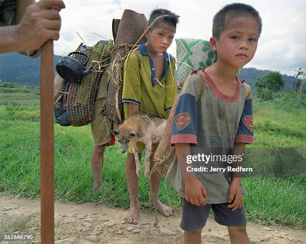 An ethnic Penan family walks with their possessions through Bario village in the Kelabit Highlands of Borneo. The Penan number about 10,000 today and...