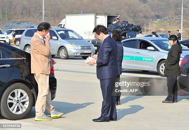 Choi Yoon-Sik a businessman of a clothing company which has a factory at the inter-Korean Kaesong Industrial Complex in North Korea, weeps next to...