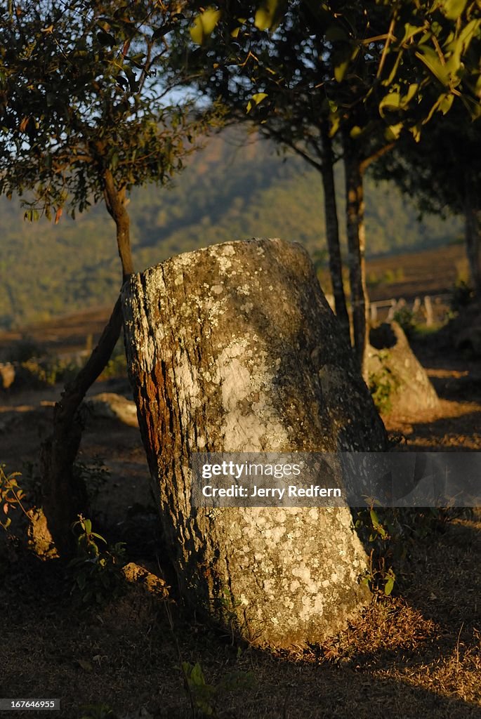 The remains of an ancient stone jar catch the last rays of...