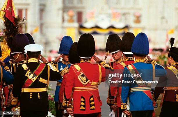 His Majesty, King Bhumibol Adulyadej of Thailand, salutes his top generals who are dressed in full honour guard regalia, during the King's annual...