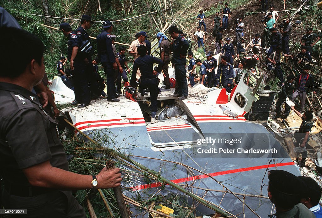 Rescue workers look through the wreckage of the crash site...