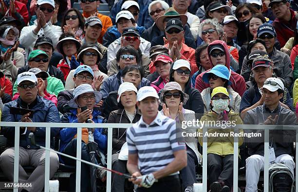 Spectators applaud as Brett Rumford of Australia is introduced on the first tee during the third round of the Ballantine's Championship at Blackstone...