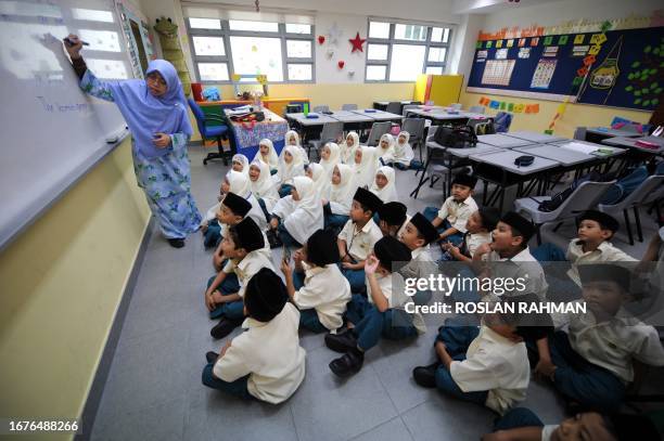 To go with story Singapore-education-religion-Islam-Asia by Philip Lim Madrasah are seen on January 14, 2009 during their class lesson at Madrasah...