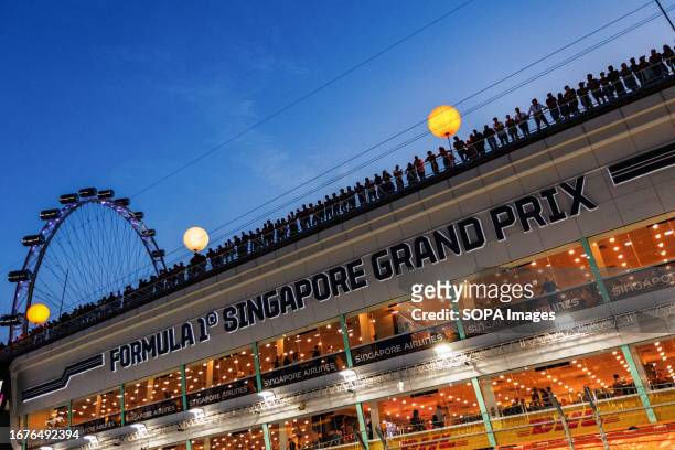 Spectators line the top of the main straight grandstand ahead of the F1 Grand Prix of Singapore at the Marina Bay Street Circuit.