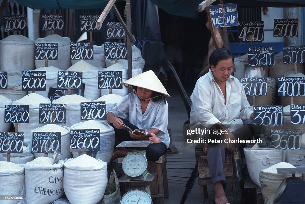 People Selling Rice Vendors selling rice displayed in the street at the front of their ...