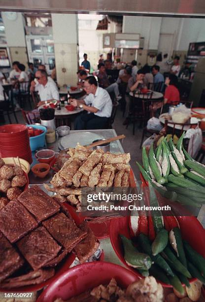 Chillies vegetables and other foodstuffs are piled up on a counter where food is prepared in the front of the Seng Hua Eating House in Singapore's...