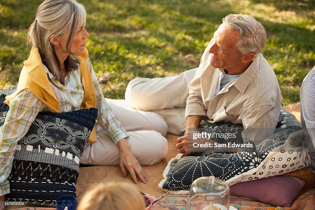 Older couple relaxing on blanket outdoors