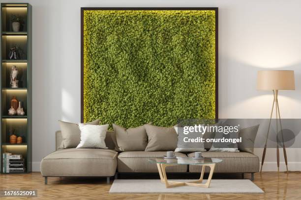 modern living room with beige sofa, coffee table, floor lamp and vertical garden - lounge pillow imagens e fotografias de stock