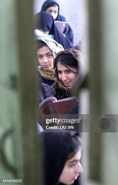 An Afghan student girl reads a text book in a lesson at Halfat high school which has some 500 students in the capital city of Kabul of Afghanistan,...