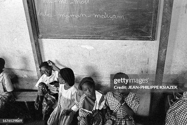 Children attend 22 March 2001 class in a Koranic school in a low-income neighborhood of Abidjan. Muslim children in Abidjan's poor neighborhoods of...