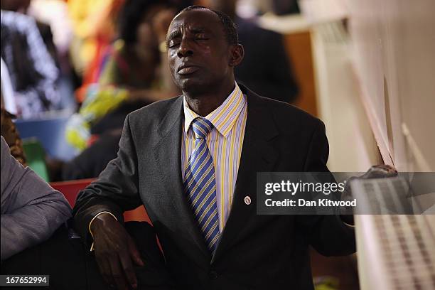 Man prays during a 'Seventh Day Evangelist' service at Crossway Church in the Heygate Estate on April 27, 2013 in London, England. The Crossway...