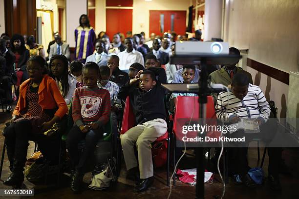 Children listen during a 'Seventh Day Evangelist' service at Crossway Church in the Heygate Estate on April 27, 2013 in London, England. The Crossway...