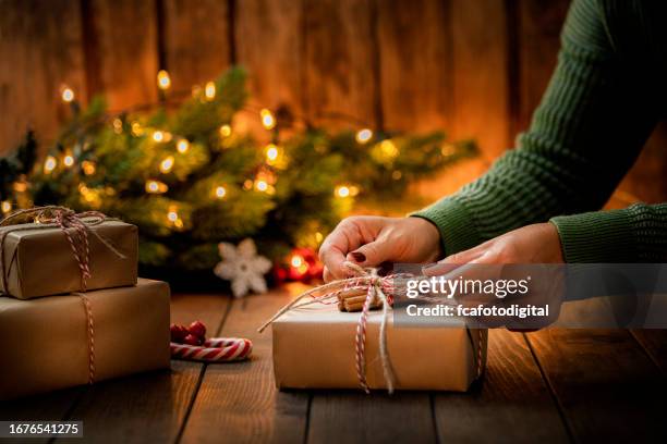 woman's hands arranging a christmas present - giving tree stock pictures, royalty-free photos & images