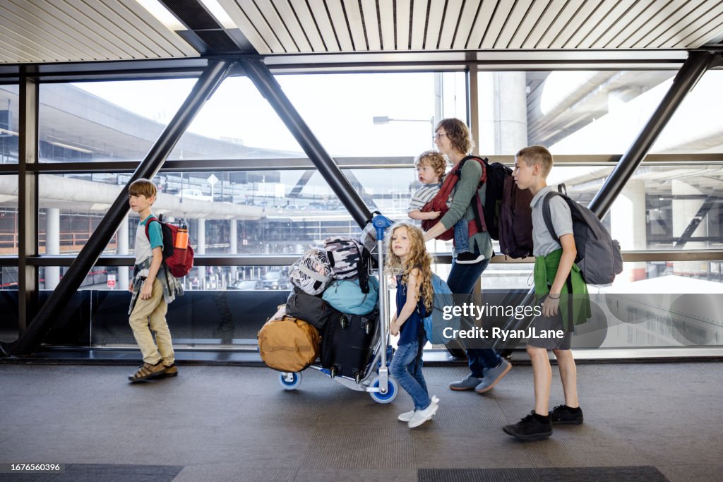 Family Navigating Airport During A Vacation