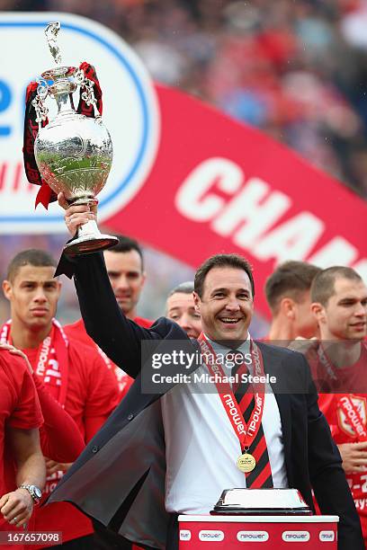 Malky Mackay the manager of Cardiff City lifts the Championship trophy after the npower Championship match between Cardiff City and Bolton Wanderers...