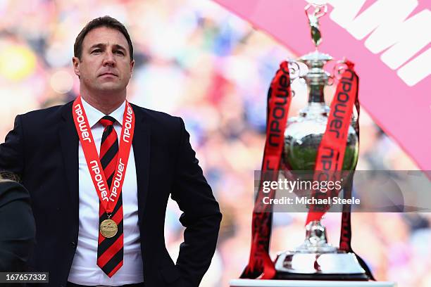 Malky Mackay the manager of Cardiff City looks towards the Championship trophy after the npower Championship match between Cardiff City and Bolton...