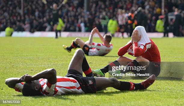 Marcello Trotta of Brentford hold his head in his hands after missing a last minute penalty that would have given his team automatic promotion during...