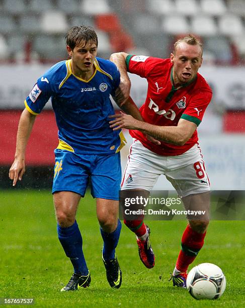 Denis Glushakov of FC Lokomotiv Moscow is challenged by Timofei Margasov of FC Rostov Rostov-on-Don during the Russian Premier League match between...