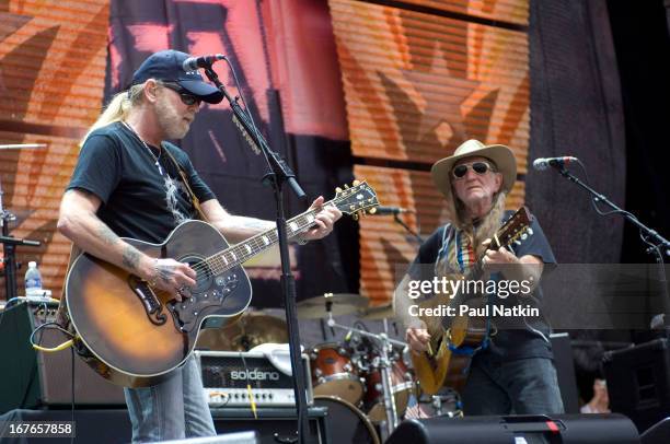 American guitarist/vocalists Greg Allman and Willie Nelson perform on stage at the 22nd Annual Farm Aid concert, Randall's Island, New York, New...