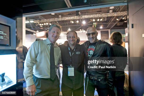 American rock musician Kenny Arnoff poses with Shure Incorporated employee Ryan Smith and a third, unidentified man at the NAMM Trade Show at the...