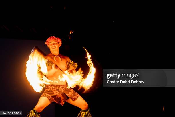 hawaiian male dancer twirls torch with hands. - fire performer stock pictures, royalty-free photos & images