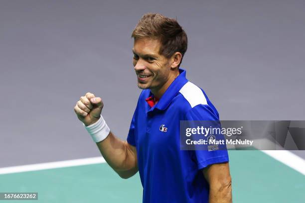 Nicolas Mahut of Team France celebrates victory after winning match point in the doubles match against Stan Wawrinka and Marc-Andre Huesler of Team...