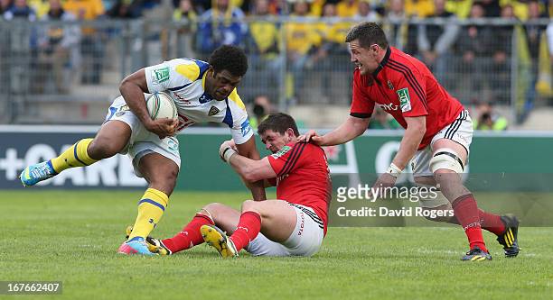 Naipolioni Nalaga of Clermont Auvergen is tackled by James Downey and Peter O'Mahony during the Heineken Cup semi final match between Clermont...
