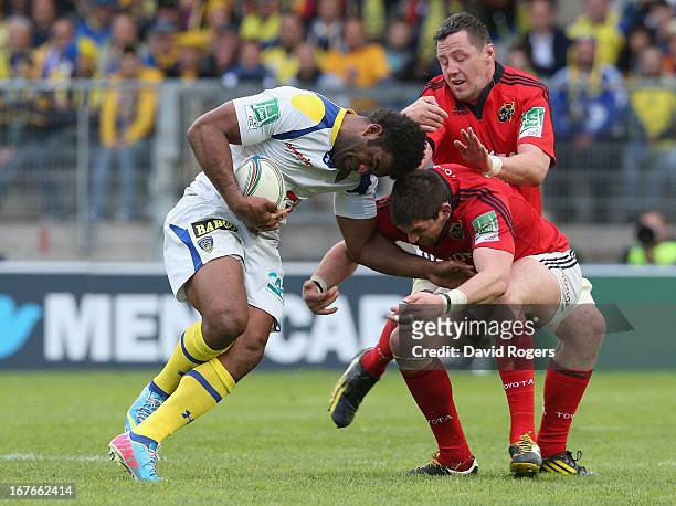 Naipolioni Nalaga of Clermont Auvergen is tackled by James Downey and Peter O'Mahony during the Heineken Cup semi final match between Clermont...