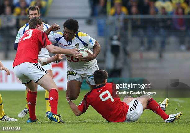 Naipolioni Nalaga of Clermont Auvergne is tackled by Denis Hurly and Conor Murray during the Heineken Cup semi final match between Clermont Auvergne...