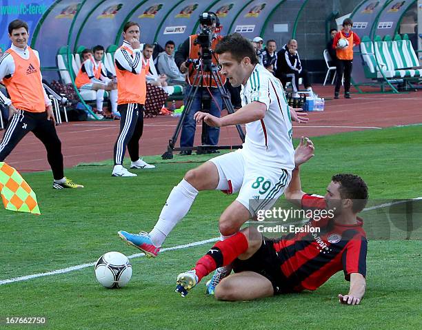 Maciej Makuszewski of FC Terek Grozny is challenged by Nikita Burmistrov of FC Amkar Perm during the Russian Premier League match between FC Terek...