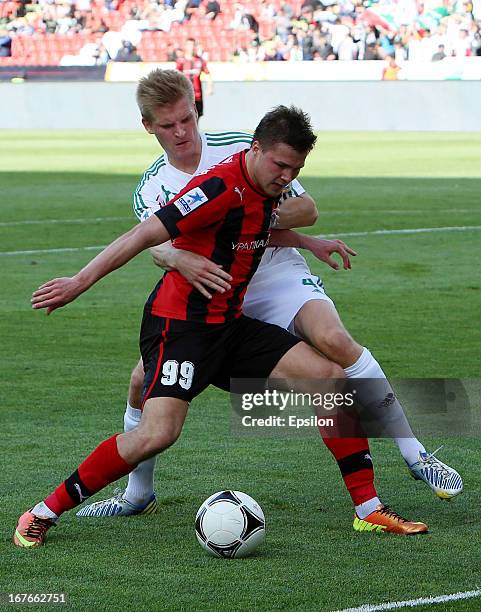 Juhani Ojala of FC Terek Grozny is challenged by Maksim Kanunnikov of FC Amkar Perm during the Russian Premier League match between FC Terek Grozny...