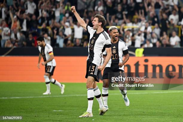 Thomas Mueller of Germany celebrates after scoring the team's first goal during the International Friendly match between Germany and France at Signal...