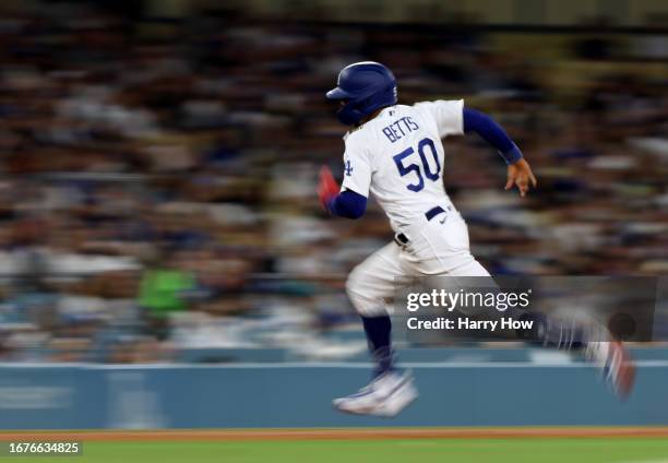 Mookie Betts of the Los Angeles Dodgers runs to third during the sixth inning in an 11-8 loss to the San Diego Padres at Dodger Stadium on September...