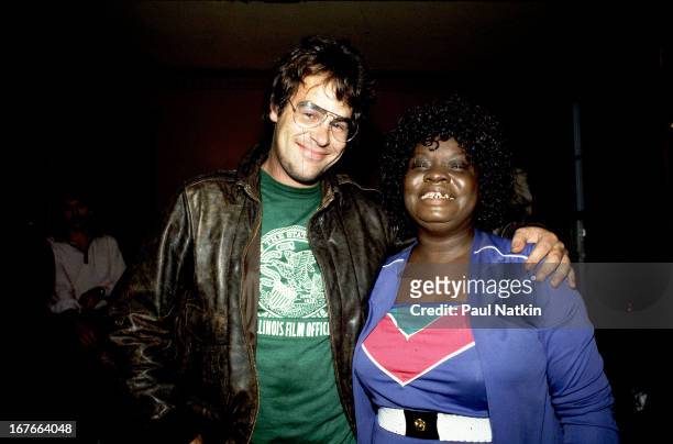 Portrait of American comedian and singer Dan Aykroyd and blues singer Koko Taylor as they pose together, Chicago, Illinois, October 19, 1982.