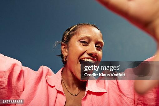 Young woman screaming against sky Young woman screaming against sky
