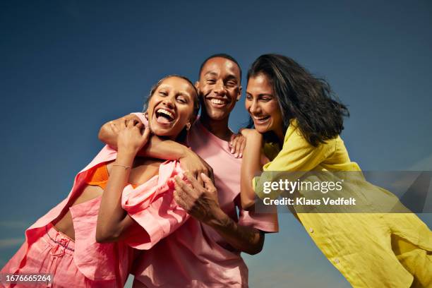 cheerful friends laughing against sky - estilo imagens e fotografias de stock