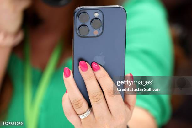 An attendee inspects the new iPhone 15 Pro during an event at the Steve Jobs Theater at Apple Park on September 12, 2023 in Cupertino, California....