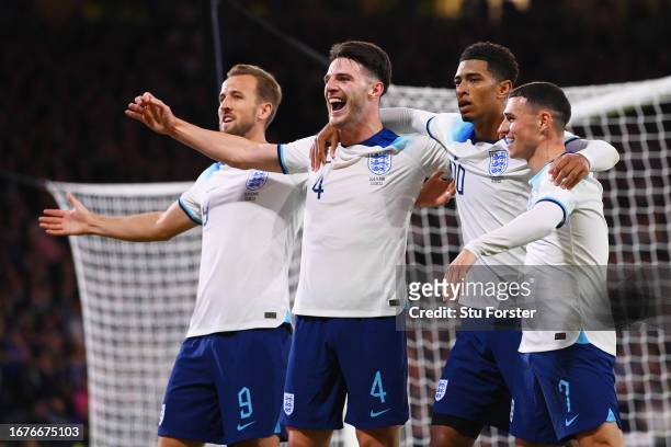 Jude Bellingham of England celebrates with teammates Harry Kane, Declan Rice and Phil Foden after scoring the team's second goal during the 150th...