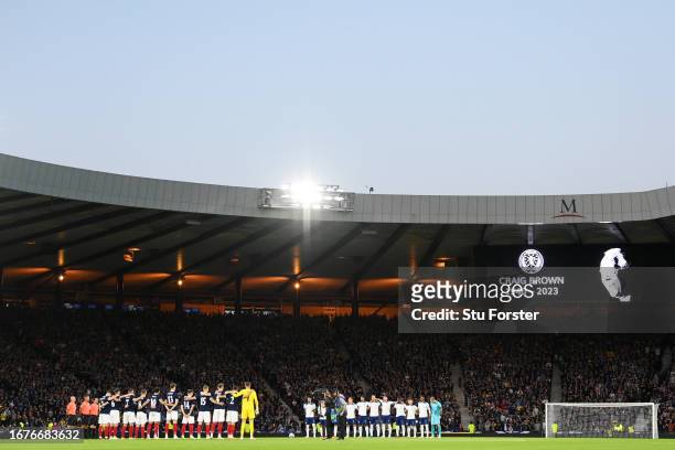 The teams take part in a minutes silence in memory of Scottish Footballer Craig Brown prior to the 150th Anniversary Heritage Match between Scotland...