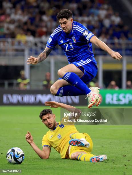 Alessandro Bastoni of Italy competes for the ball with Roman Yaremchuk of Ukraine during the UEFA EURO 2024 European qualifier match between Italy...
