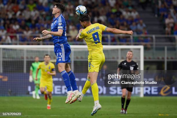 Alessandro Bastoni of Italy competes for the ball with Roman Yaremchuk of Ukraine during the UEFA EURO 2024 European qualifier match between Italy...