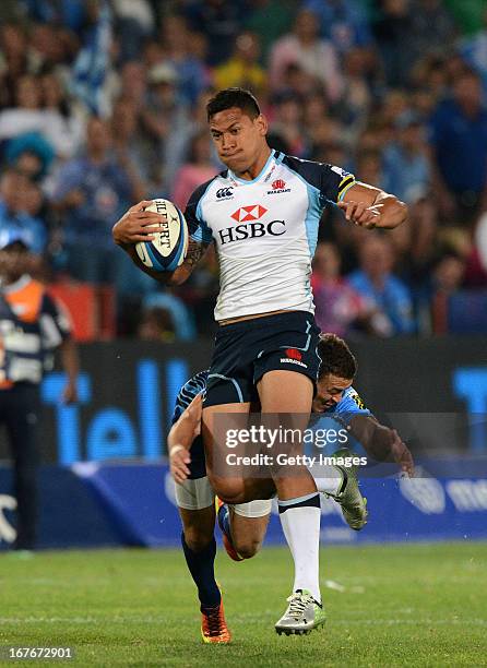 Israel Folau of the Waratahs gets tackled by Bjorn Basson of the Bulls during the Super Rugby match between Vodacom Bulls and Waratahs at Loftus...