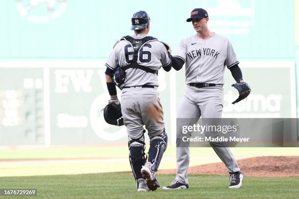 Clay Holmes of the New York Yankees celebrates with Kyle Higashioka after the Yankees defeat the Boston Red Sox 3-2 at Fenway Park on September 12,...