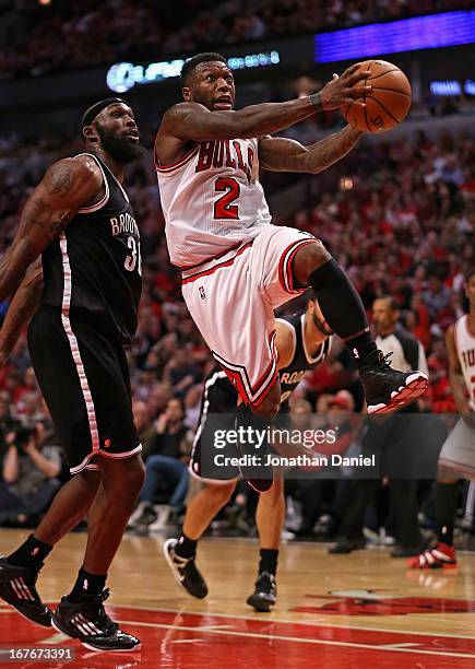 Nate Robinson of the Chicago Bulls drives to the basket past Reggie Evans of the Brooklyn Nets in Game Five of the Eastern Conference Quarterfinals...